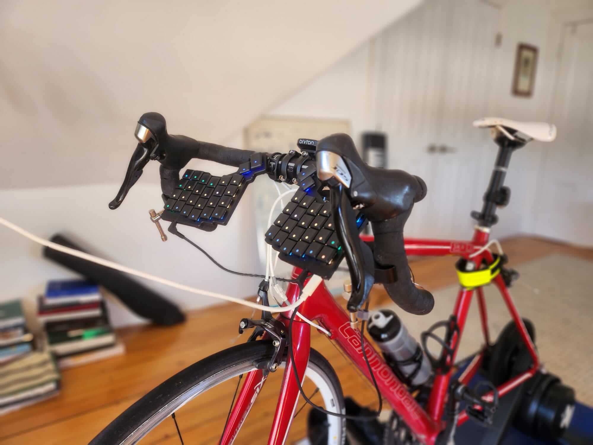 An indoor cycling setup with split keyboard on the handlebars